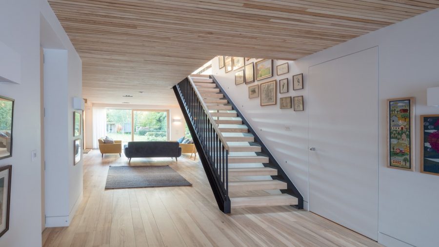 ash wood flooring, ceiling and floating wood staircase view to garden