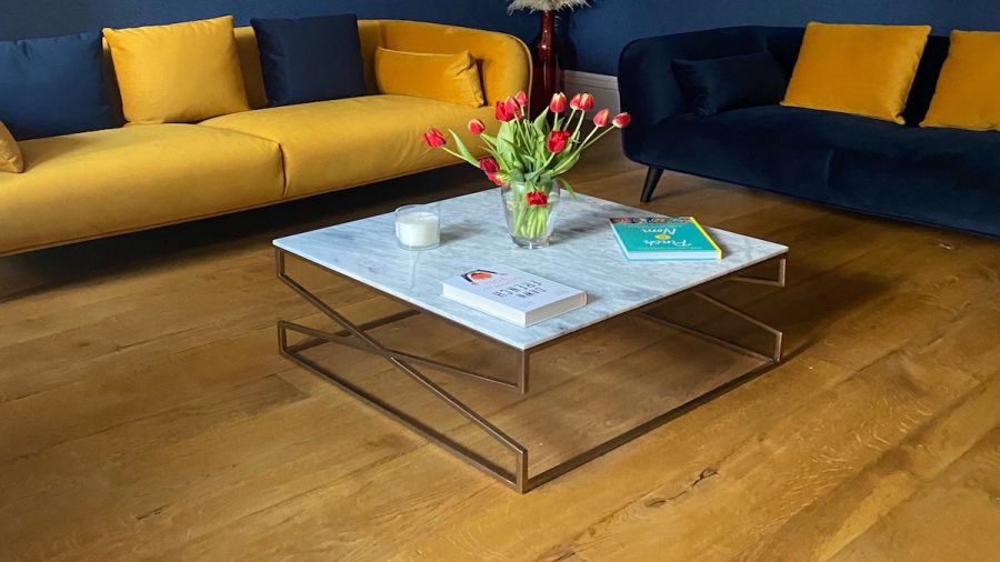 yellow and blue velvet sofas with coffee table and oak floor