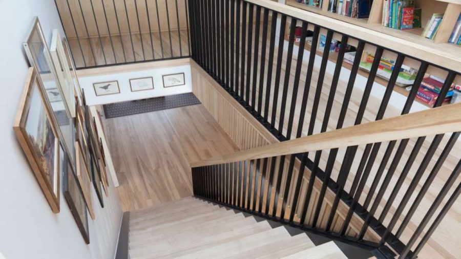 view looking down onto ash staircase with black metal balustrades