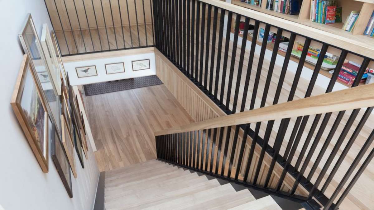 ash wood staircase with black steel balustrades