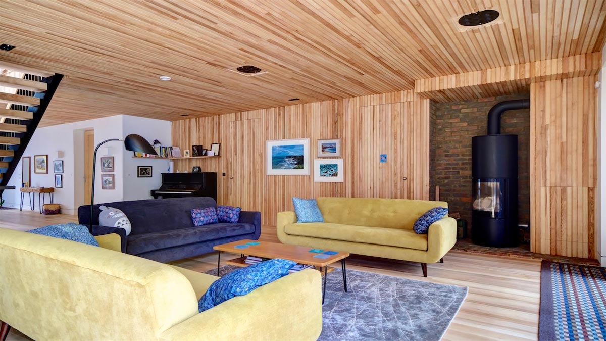 sitting room with large wood burner piano and modern sofas