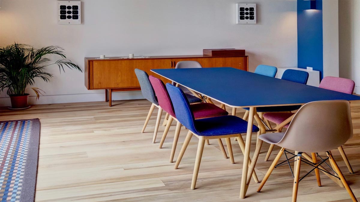 dark blue modern kitchen table with coloured seats around