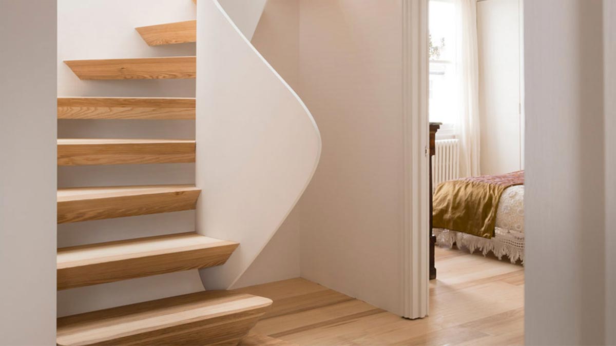 spiral stair case with floating steps view through to bedroom