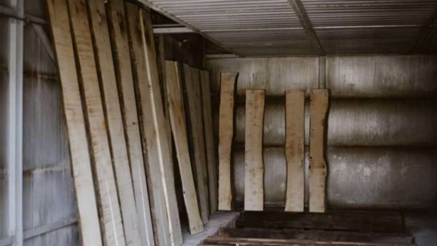 planks of wood lined up vertically in a kiln