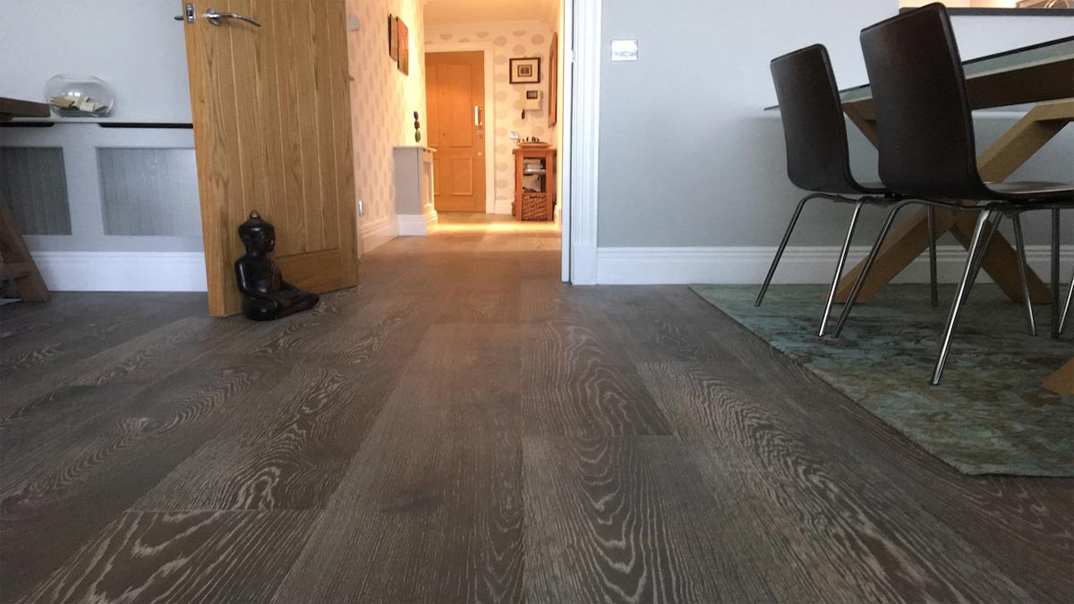 engineered flooring showing through to hallway and front door