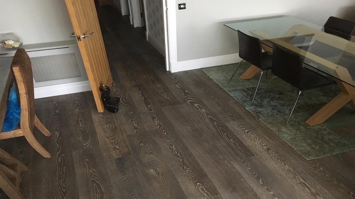 brushed engineered oak flooring in dining area with glass table and chairs