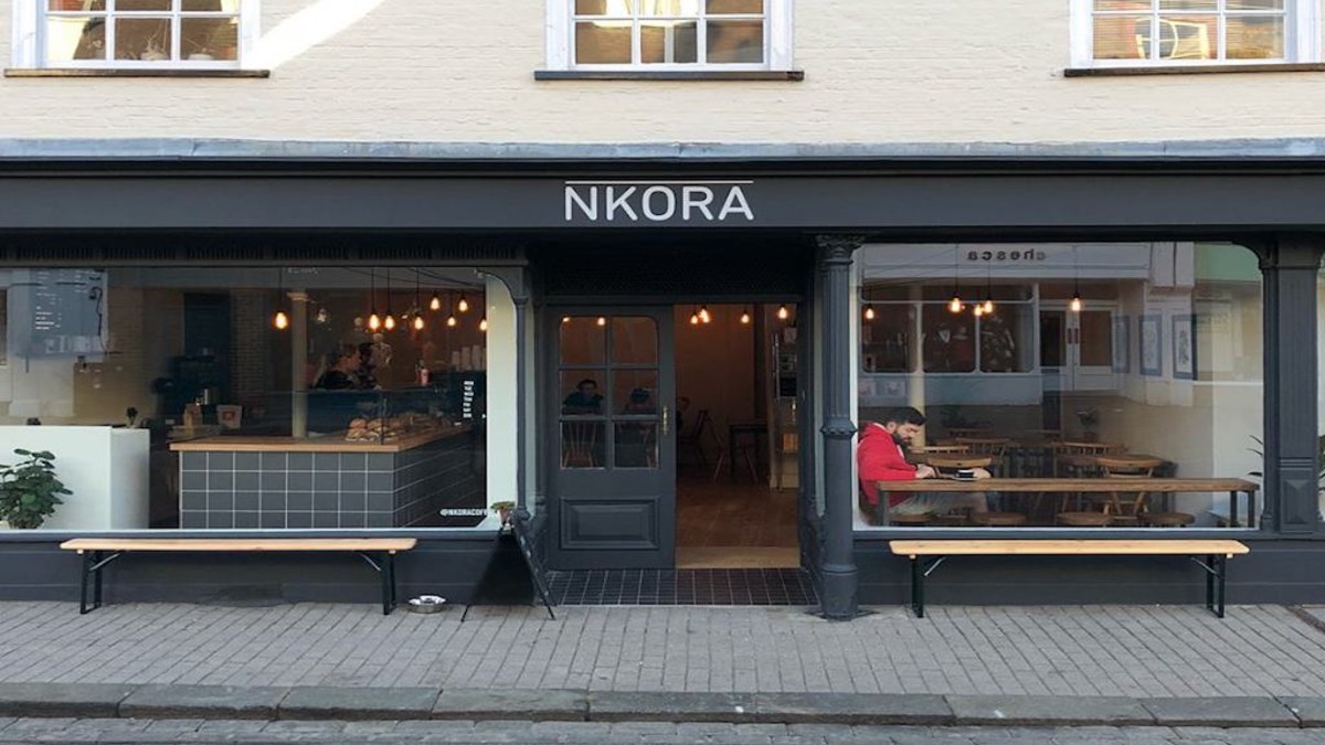 Coffee shop front with man at table in window