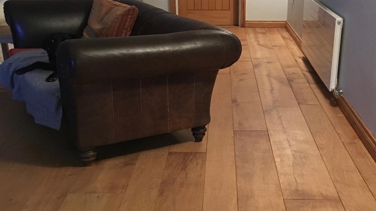 dark leather sofa with oak flooring