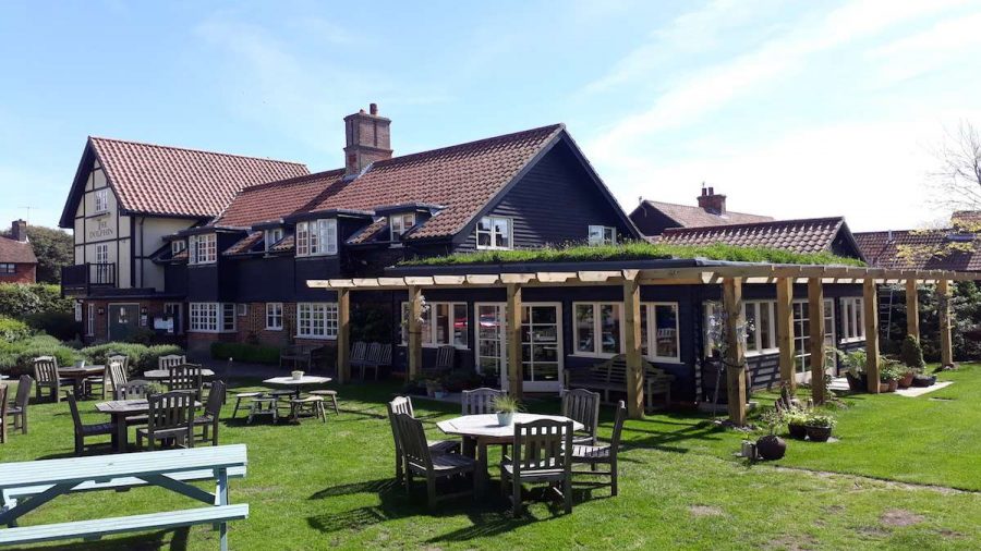 pub garden in summer with tables outside and pergola