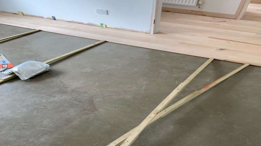 fitting wood flooring boards over concrete base