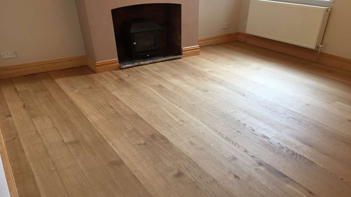 fireplace with woodburner with oak floor