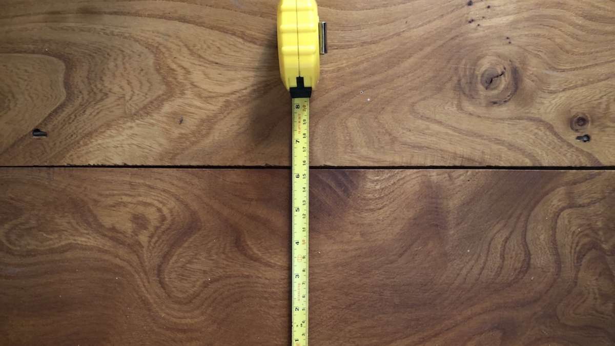 tape measure on wood floorboards
