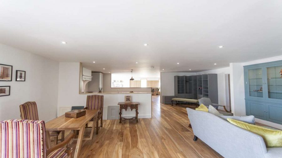 showroom image of sitting room and dining room with elm flooring