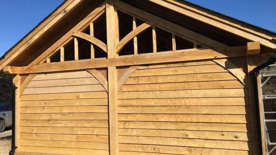 timber clad side of barn with oak framing