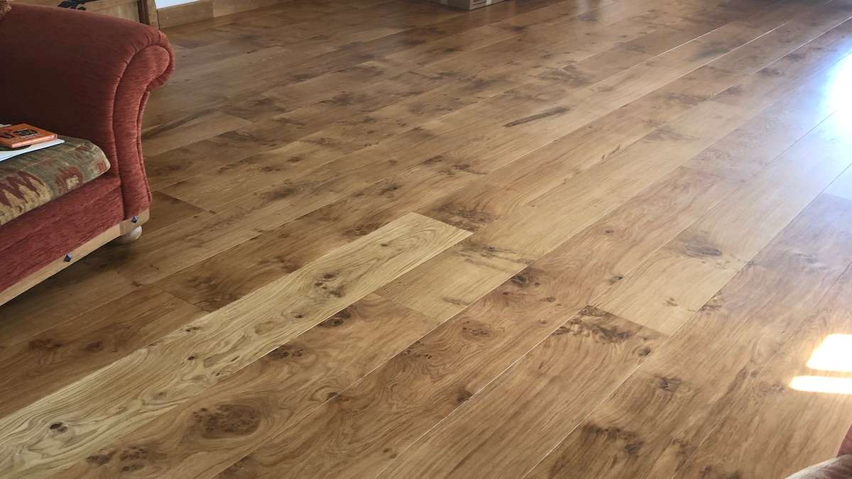 pippy oak flooring with edge of fabric chair in sitting room