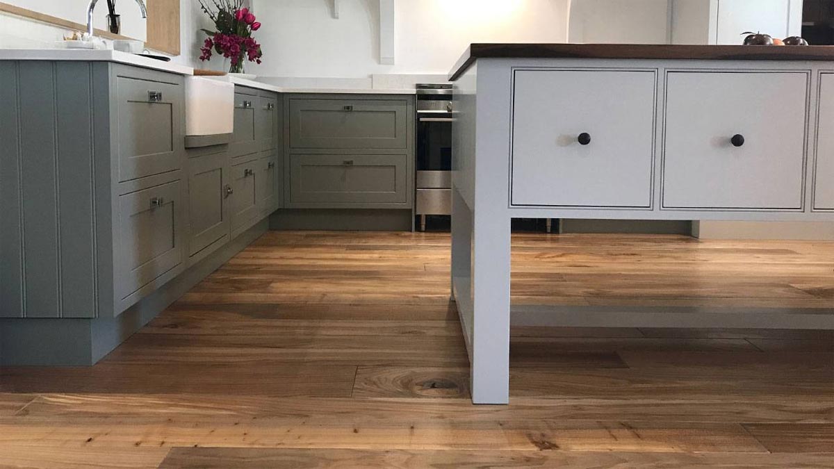 corner of island in kitchen with green cabinetry