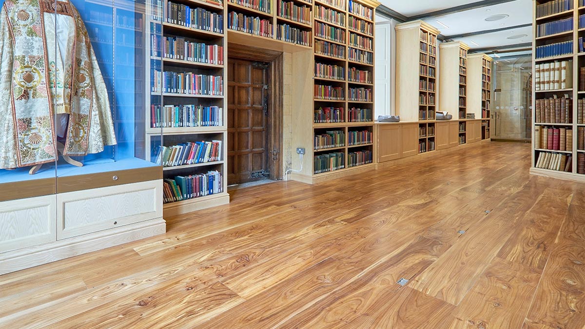 bishops cassock display in library full of books and elm floor