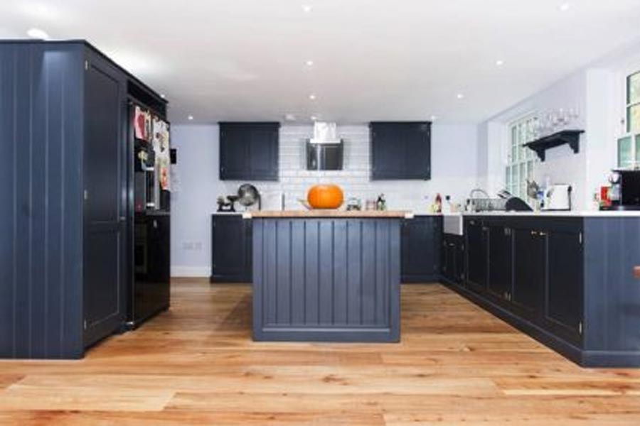 solid elm kitchen floor with dark blue painted cabinetry