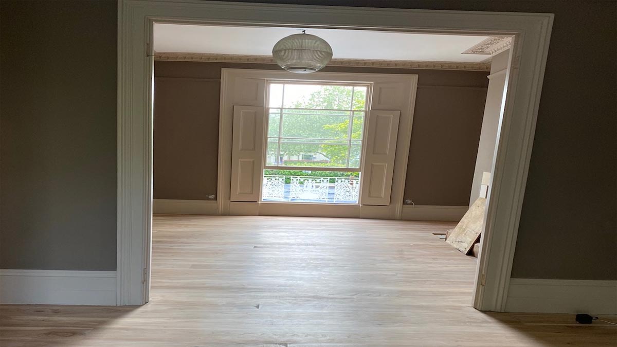 square archway with elm flooring in room with floor to ceiling window