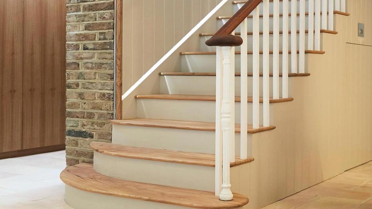 bottom of stairs with oak treads and white paintwork