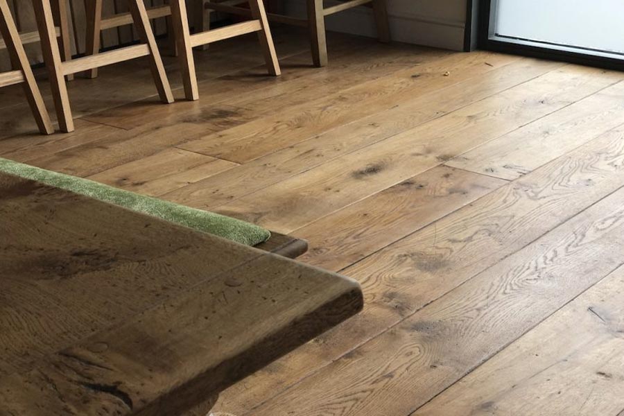 solid oak floorboards with corner wood table and stools