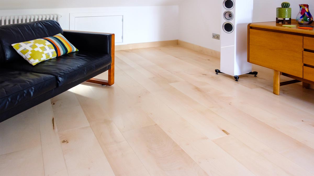 pale sycamore wood flooring in sitting room with sofa and side board