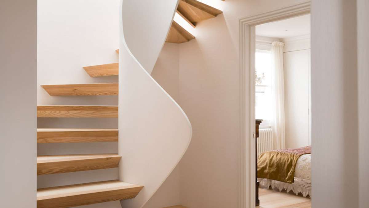 spiral staircase with open treads and view to bedroom