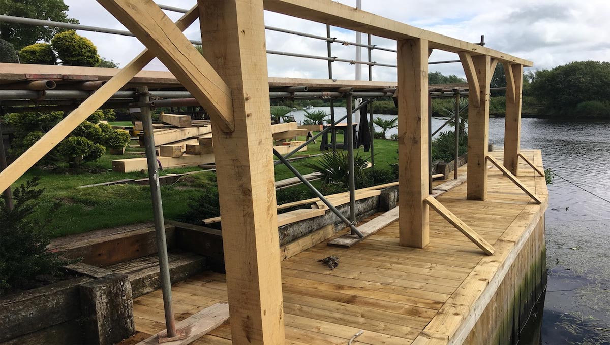structural oak beams at side of river to form part of boat house