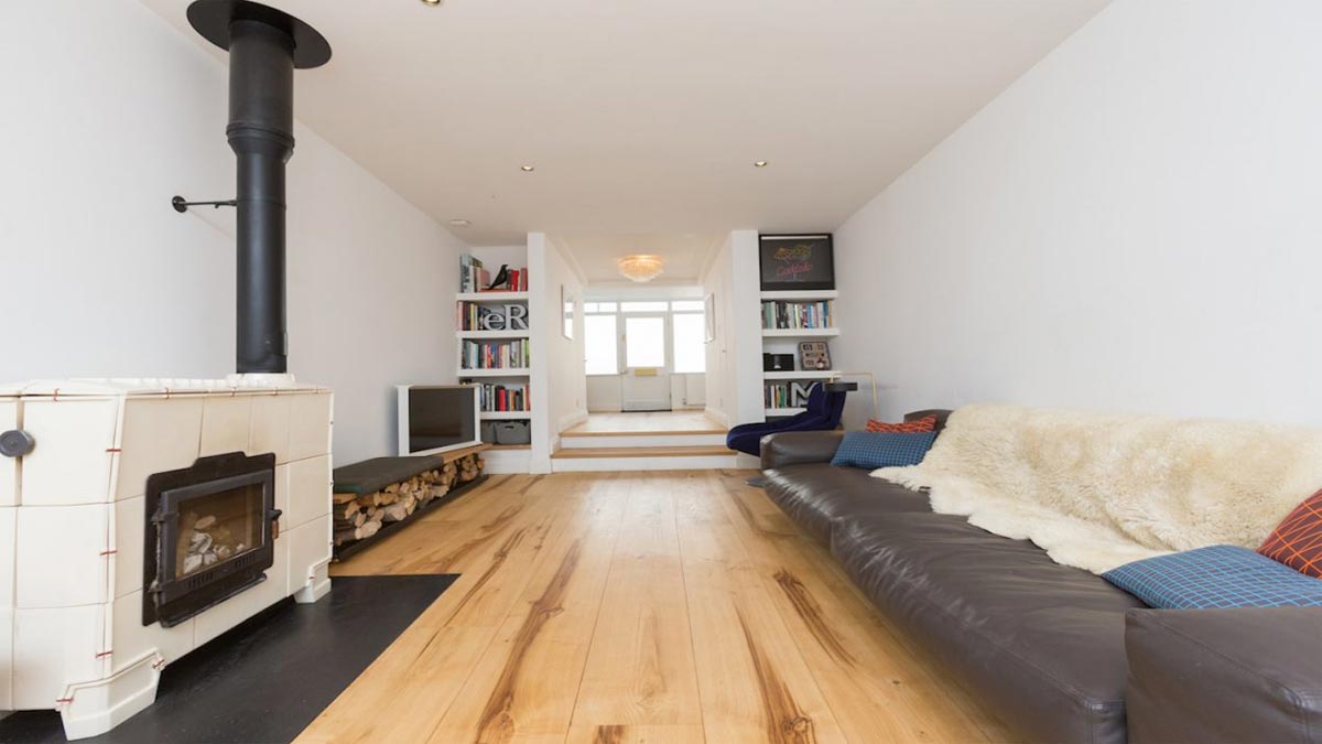 sweet chestnut flooring in sitting room with woodburner and bookshelves